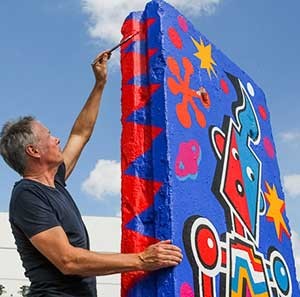 Tim Davies at work on his Berlin Wall painting